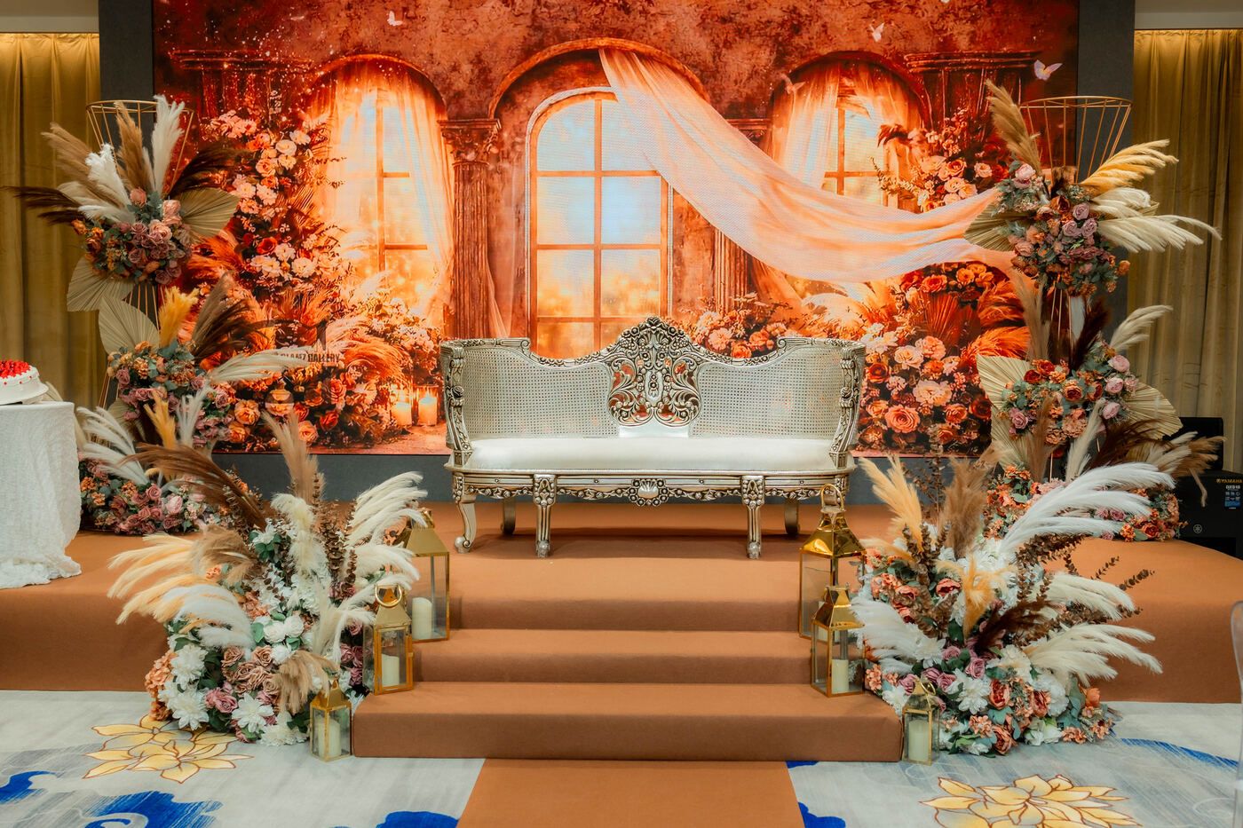 Warm wedding stage with floral aisle and ornate seating