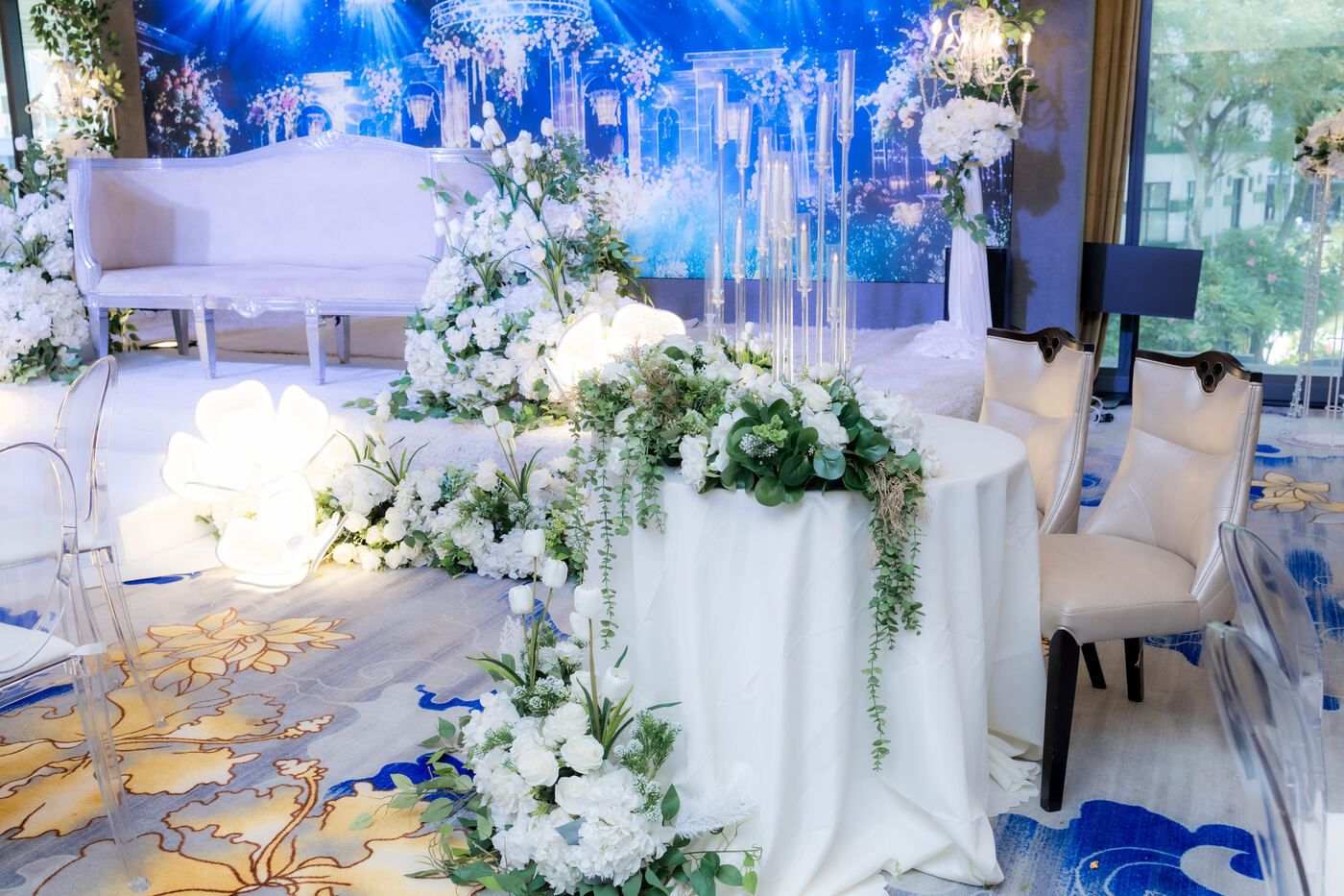 White solemnisation stage with floral arrangements
