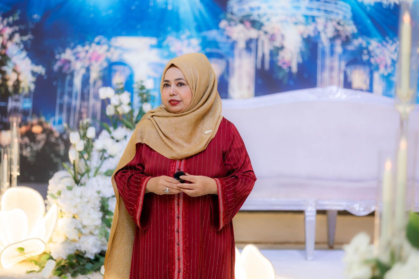 Speaker standing clearly in front of the decorated stage